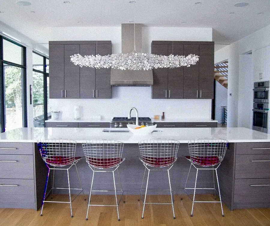 Kitchen with a waterfall island and integrated hood — YKCA Bay Area remodel