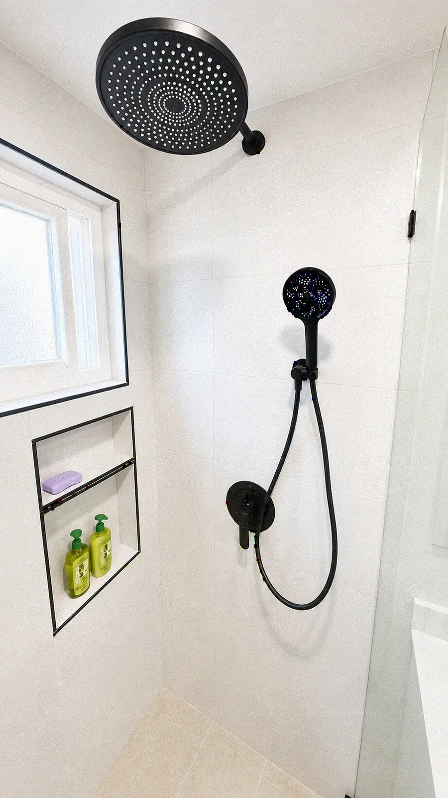 Walk-in shower with rain head and matte black fixtures — YKCA Bay Area remodel