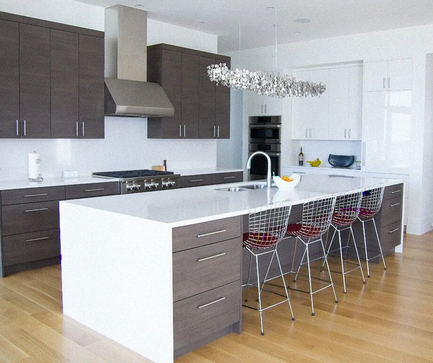 Bay Area kitchen remodel by YKCA — waterfall island, integrated hood and new lighting